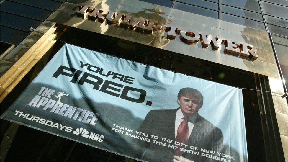A advert for The Apprentice hung at Trump Tower